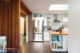 Mahogany slat focal point that separates the kitchen from the living room while leaving it open